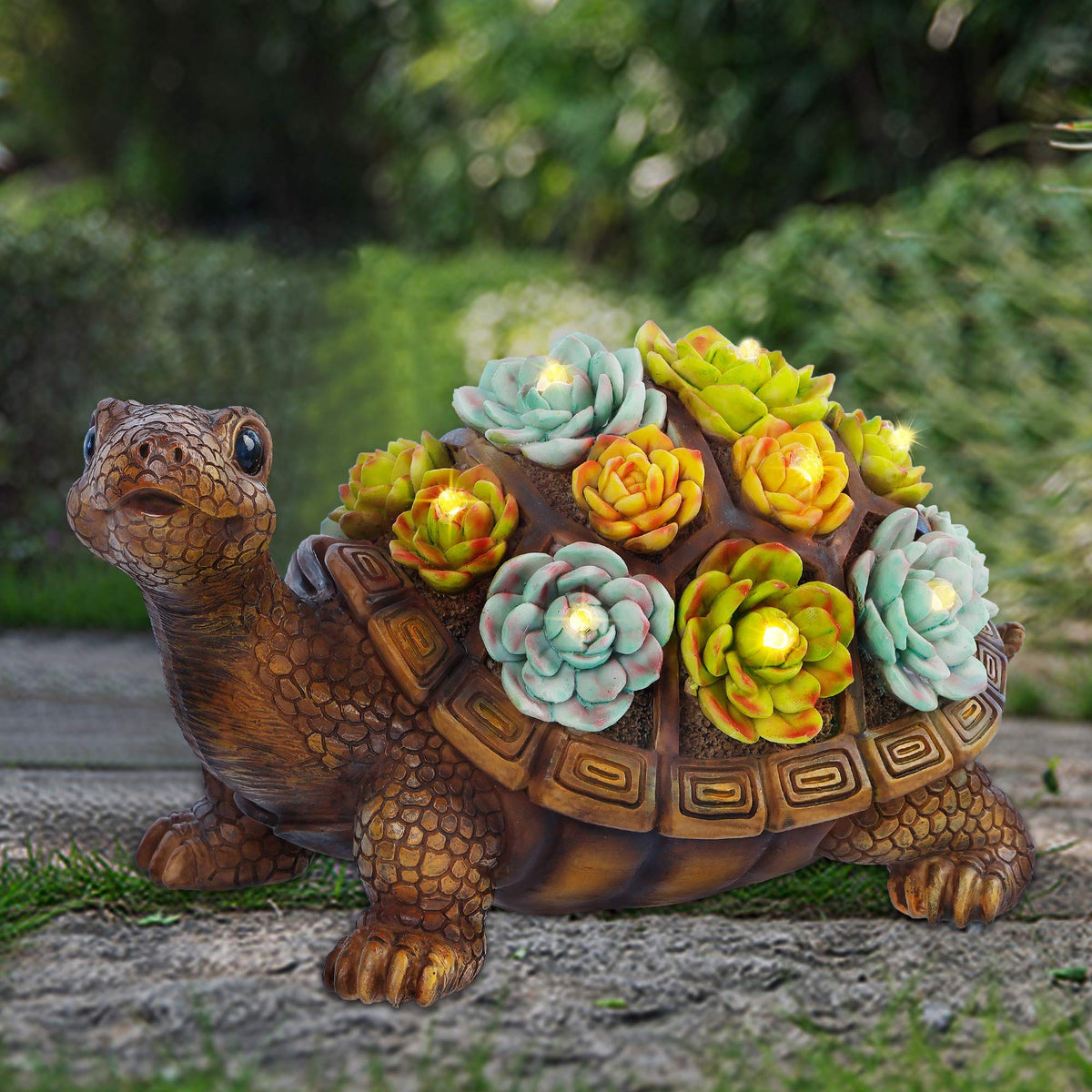 FORUP Turtle Garden Statue with solar LED lights glowing at dusk