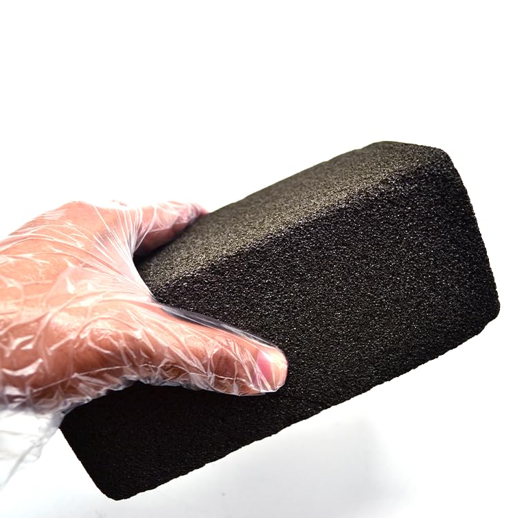 Pumice brick removing carbon build-up on flat top grills safely
