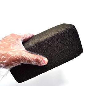 Pumice brick removing carbon build-up on flat top grills safely