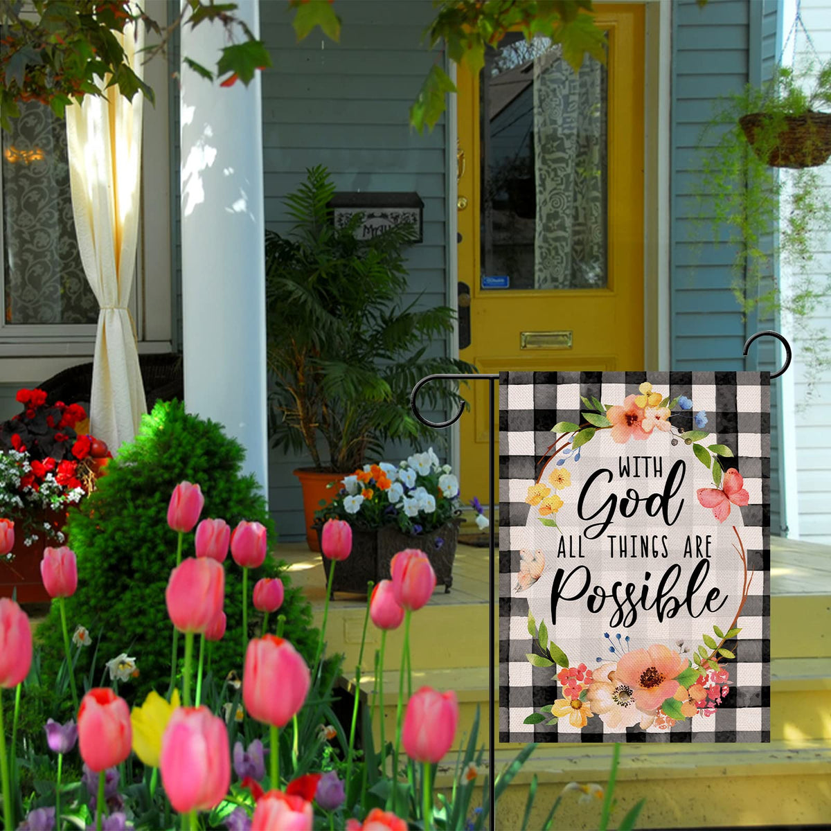 Furiaz checkered yard flag displayed on a fence with spring flowers