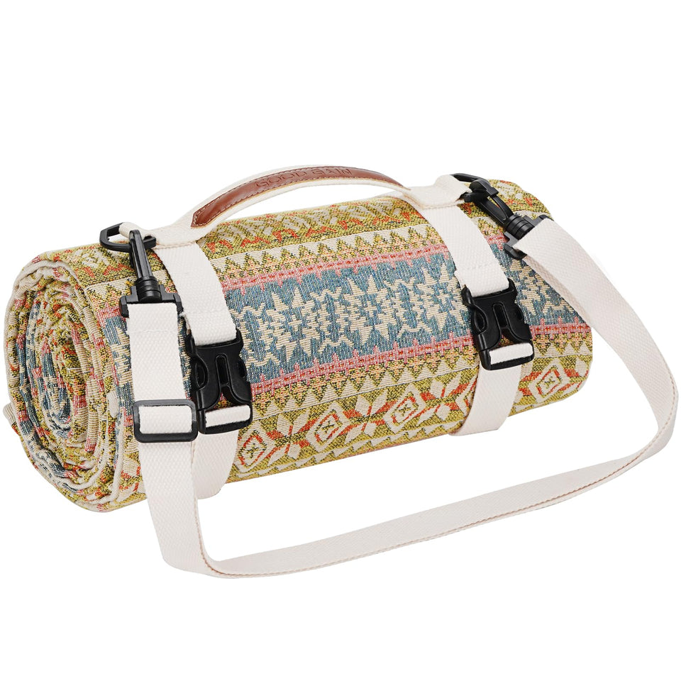 G GOOD GAIN picnic blanket folded with shoulder strap for easy carrying.