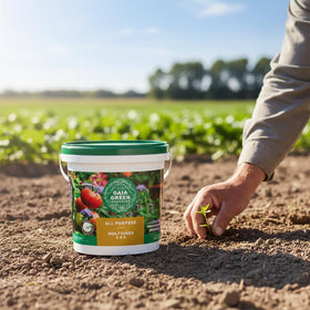 Gaia Green All Purpose Soil Supplement being applied to garden bed soil