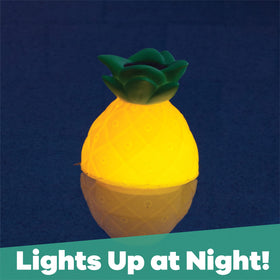 GAME Pineapple chlorinator glowing at dusk for nighttime pool maintenance