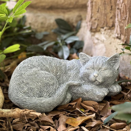 Garden Whisper cat memorial statue laying in the garden for serene remembrance.