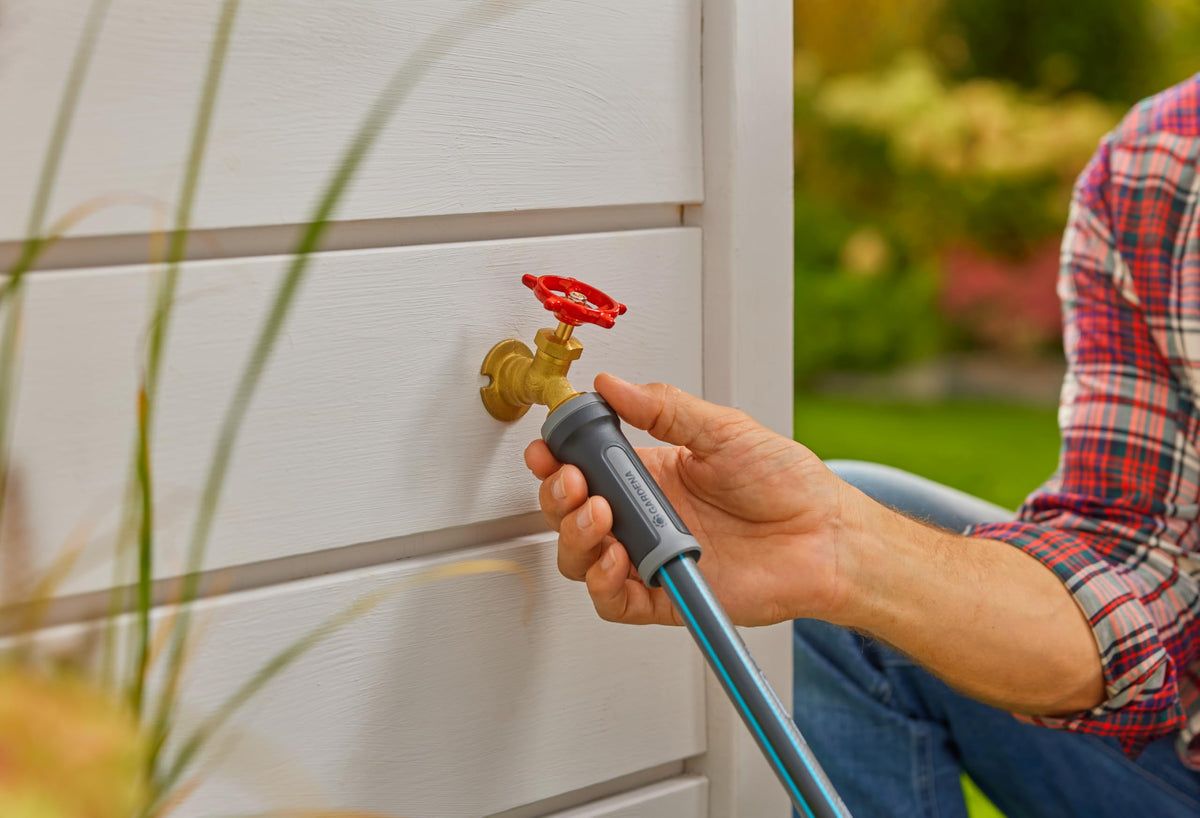 Gardena adjustable spray nozzle providing versatile watering control for gardens and patios.