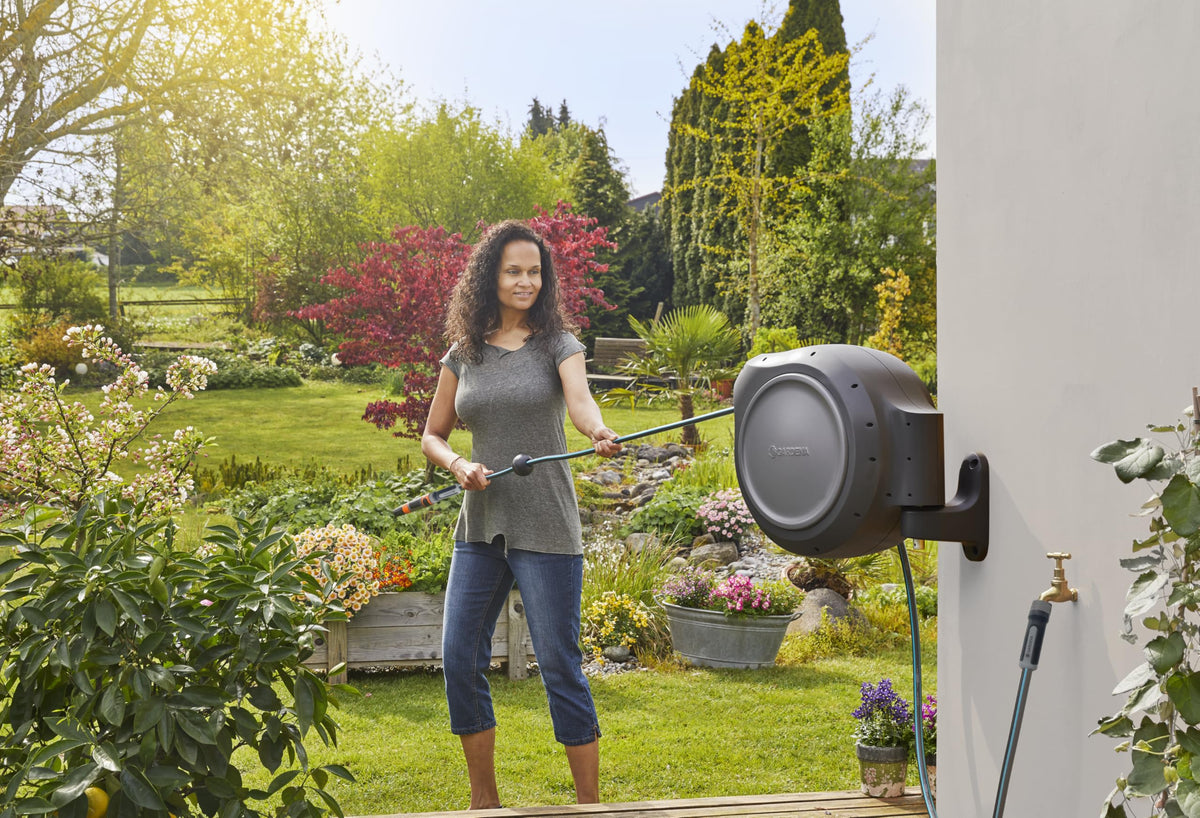 Gardena outdoor hose reel mounted in garden, saving space and reducing tangles.