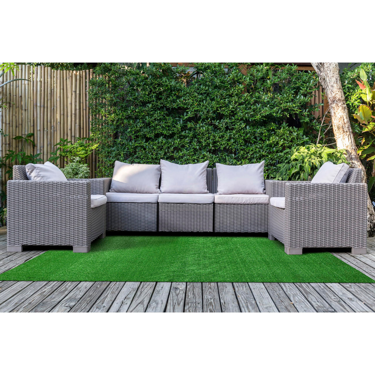 Garland Rug artificial grass 5x7 on patio for outdoor ambiance.