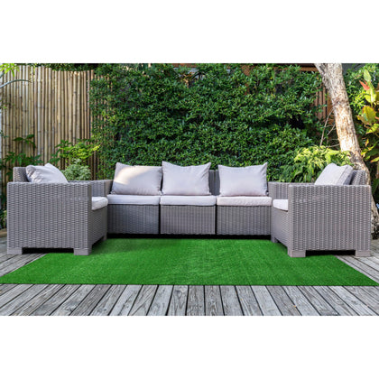 Garland Rug artificial grass 5x7 on patio for outdoor ambiance.