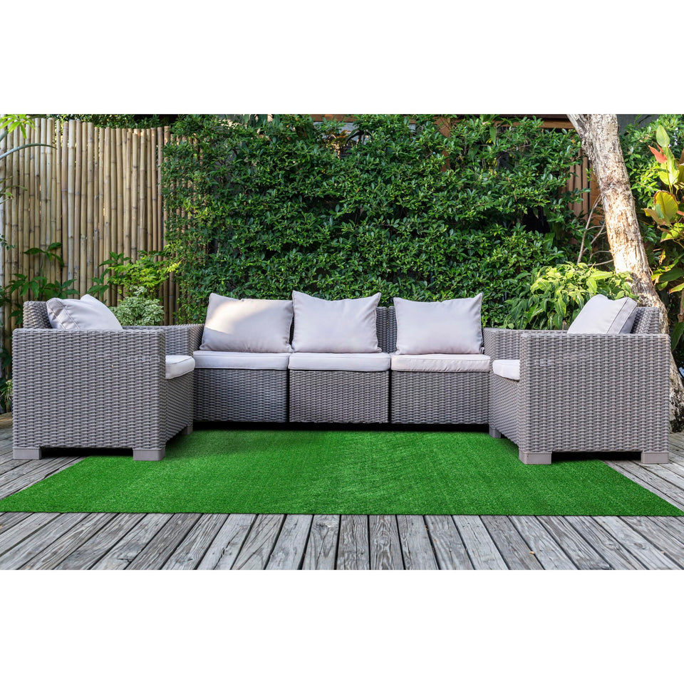 Garland Rug artificial grass 5x7 on patio for outdoor ambiance.