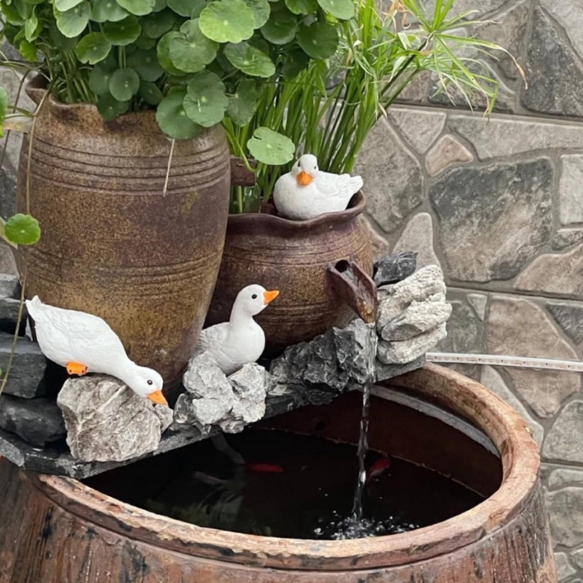 GBHKPLFO duck ornament on planter elevates your patio with whimsy