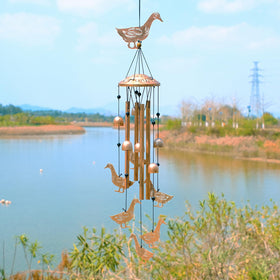 GDNSFIT duck wind chimes outdoors featuring six smaller ducks for playful yard decor.