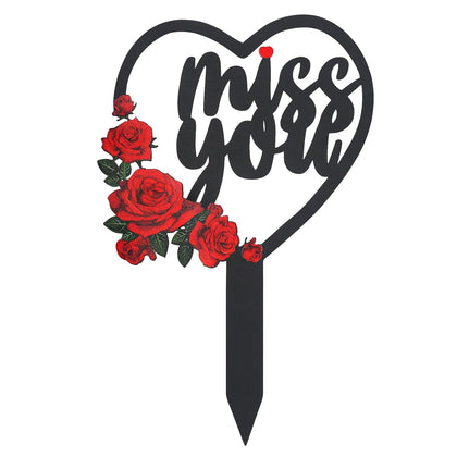Generic metal cemetery memorial plaque with heart and flowers for outdoor sites.