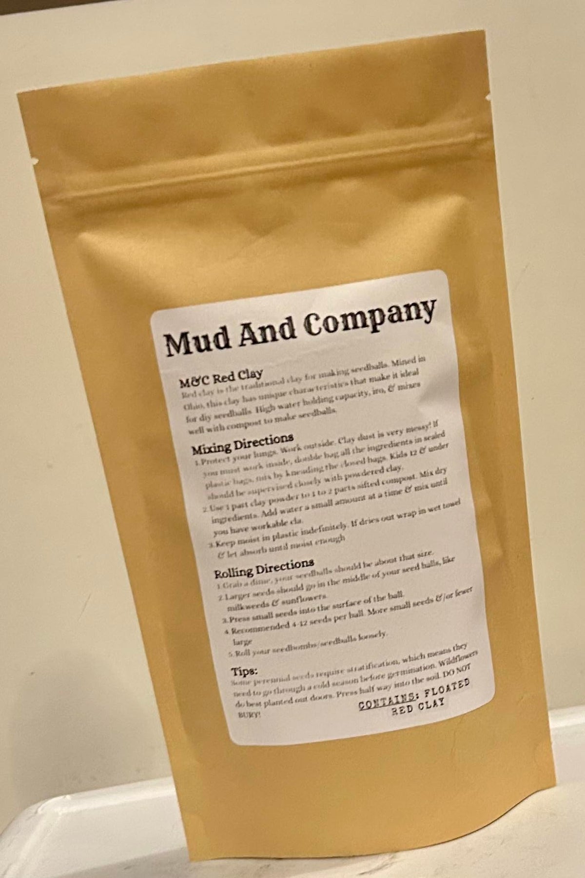 Generic Natural Red Clay Powder being mixed with water for seed bombs