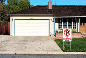 Generic No Parking sign with metal stakes for stable outdoor mounting.