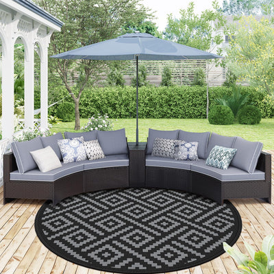 GENIMO 10ft round outdoor rug on patio with reversible two-tone design.