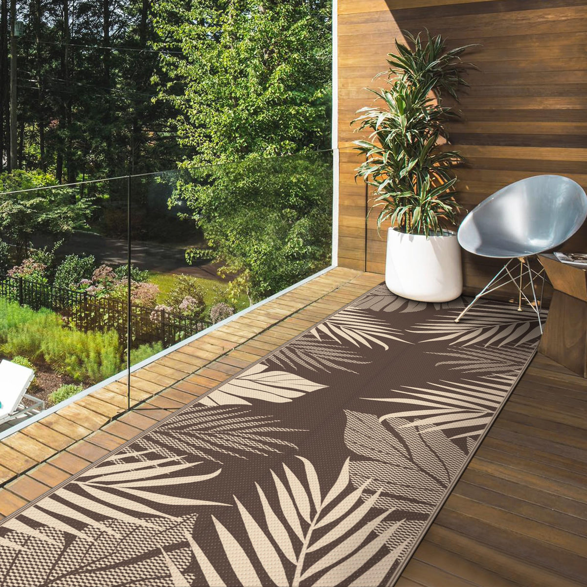 GENIMO outdoor rug folds compactly for RV trips with stakes and carry bag.
