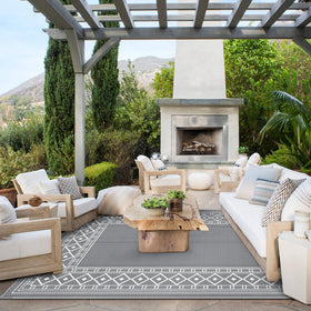 GENIMO outdoor rug on a patio setting enhances ambiance and comfort.