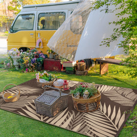 GENIMO outdoor rug ideal for RV camping, folds compactly with stakes included.