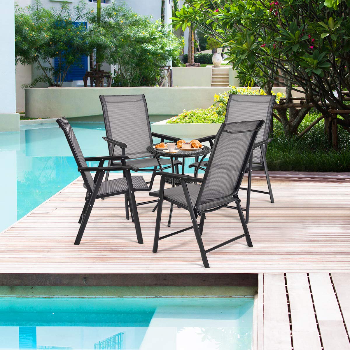 Giantex folding patio chairs opened on a sunny patio for casual dining.