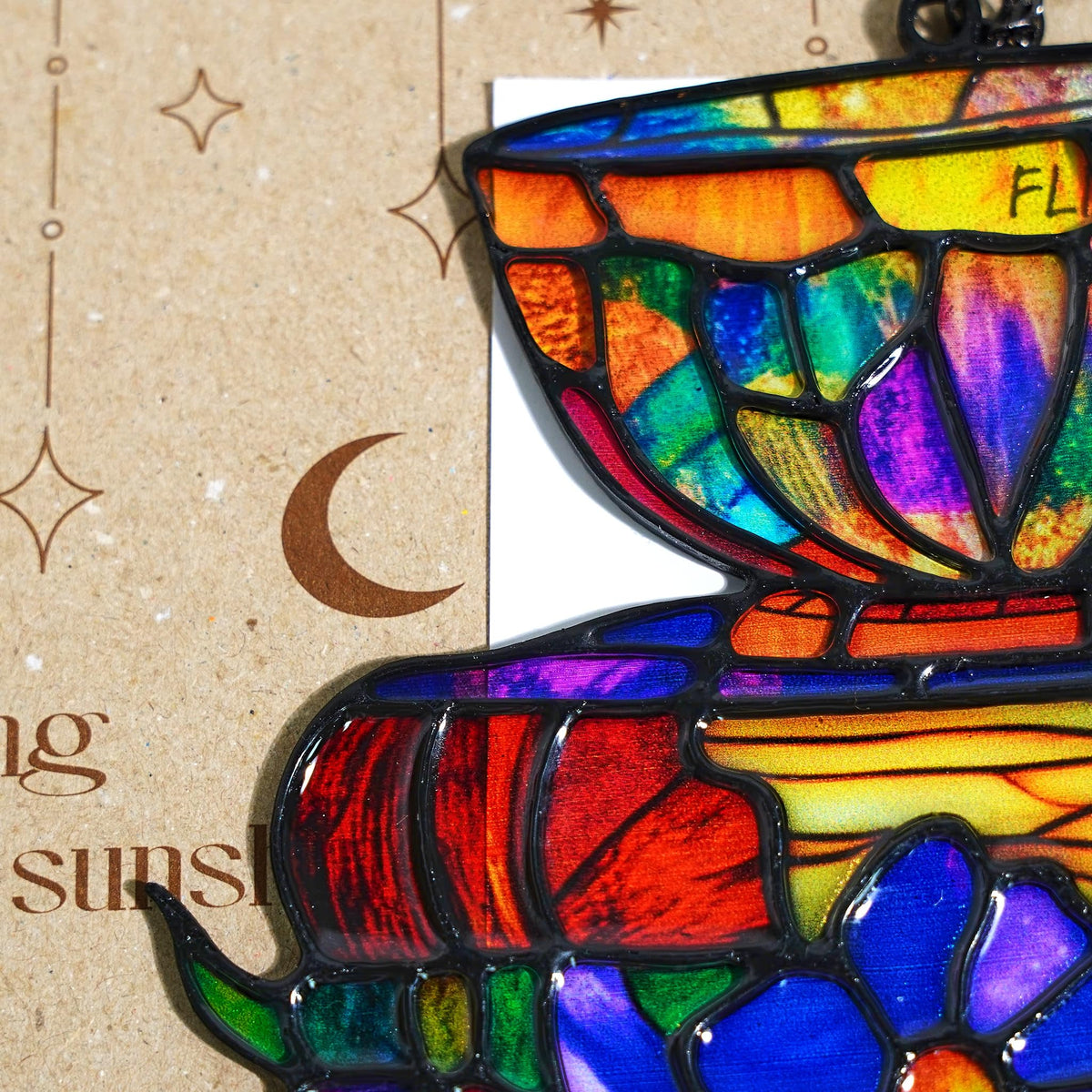GIKZO Books Teacup sun catcher hanging in a sunlit window