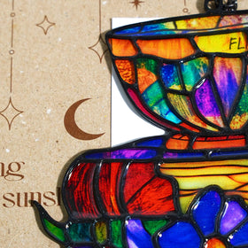 GIKZO Books Teacup sun catcher hanging in a sunlit window
