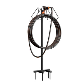 Giraffe Tools garden hose holder stand in side view stabilizing hoses outdoors.