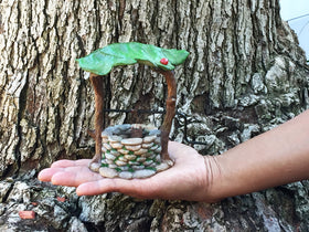 GlitZGlam miniature wishing well with water bucket enhances whimsical garden scenes.