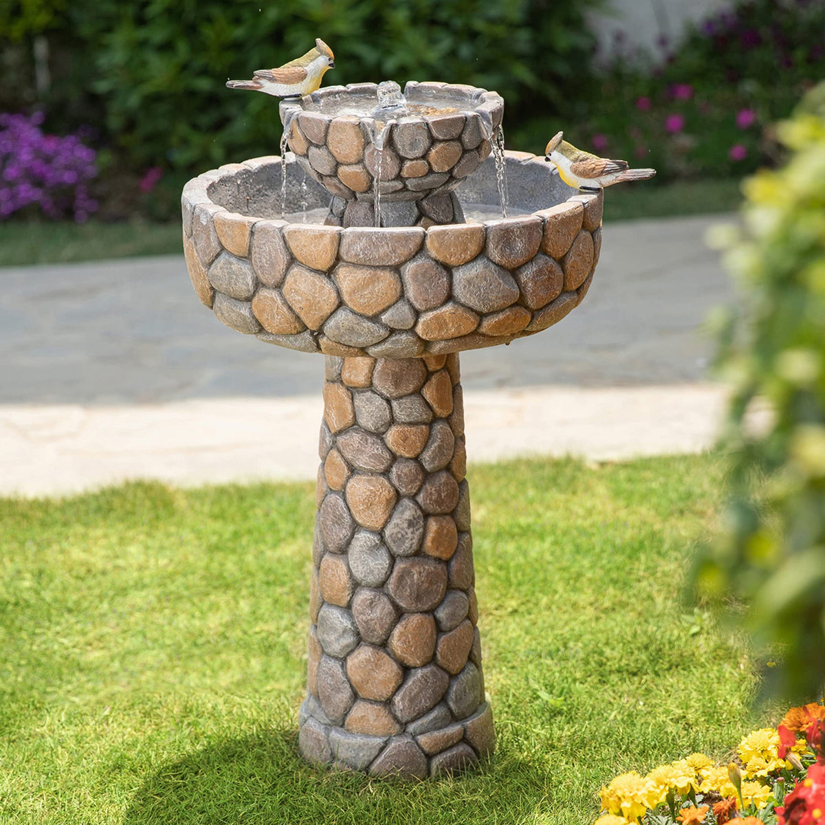Glitzhome 2-Tier Stone-Like Fountain with Birds, attracting songbirds and creating a tranquil garden focal point.