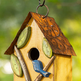Glitzhome birdhouse perched on a branch provides shelter for small birds.
