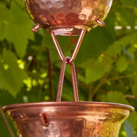 Gold & Garden rain chain installation on gutter adds outdoor charm.