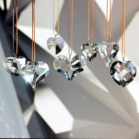 GOLDENHAITAI crystal heart prisms hung from a chandelier for shimmering light.