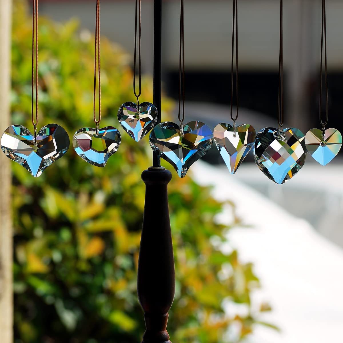 GOLDENHAITAI rainbow light prisms refract sun, brightening a window display.