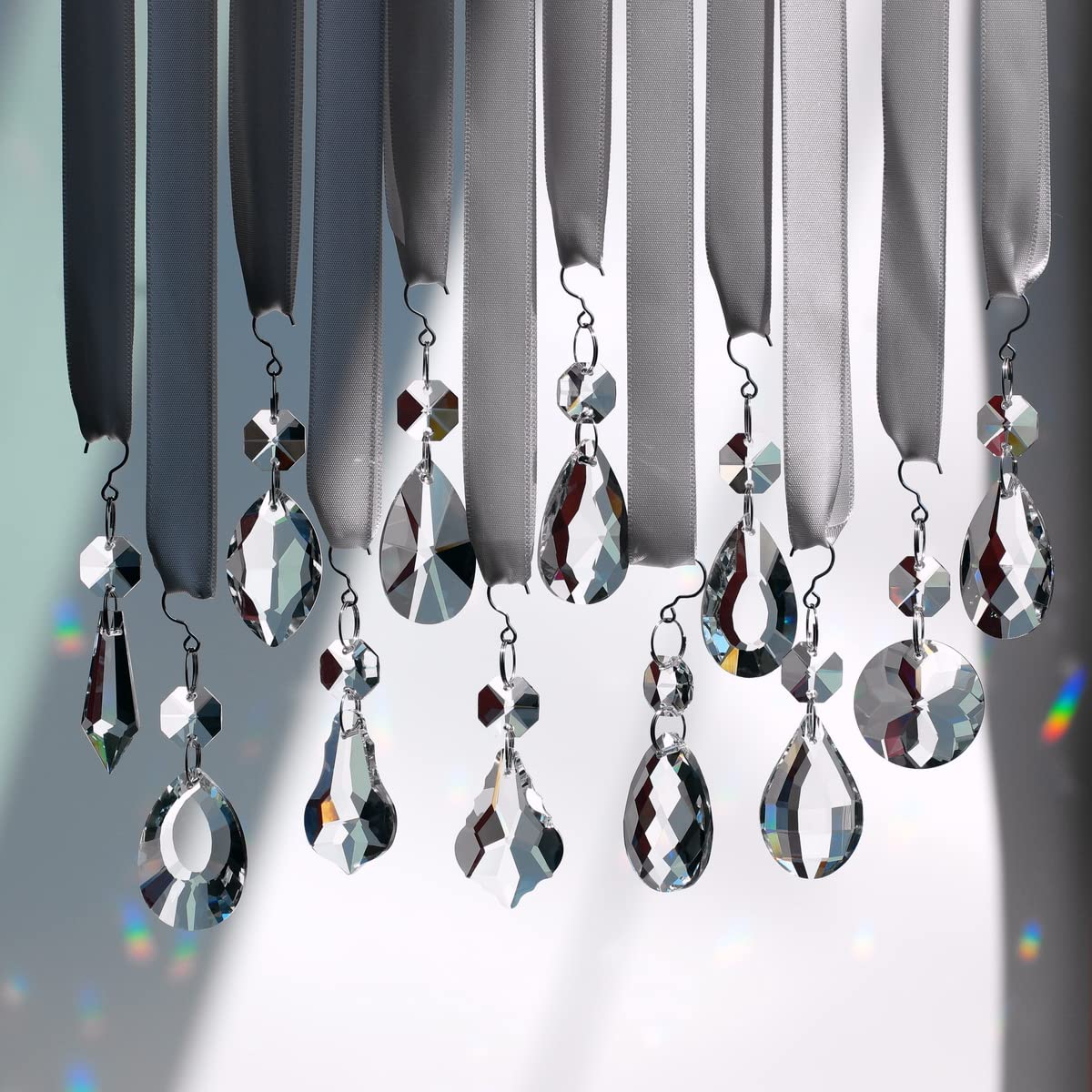GOLDENHAITAI sun catcher pendant creating colorful light displays near windows.
