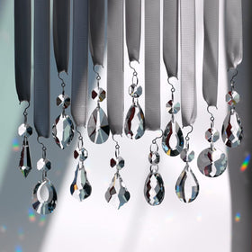 GOLDENHAITAI sun catcher pendant creating colorful light displays near windows.