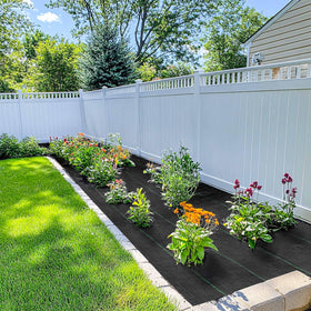 GRASSCLUB weed barrier landscape fabric used in a greenhouse setup for even moisture.