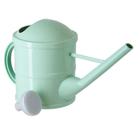 Green Farmlyn Creek watering can on shelf as a decorative garden accessory