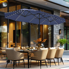GREEN PARTY 13 ft rectangle umbrella with solar lights in navy blue shading a large outdoor dining area