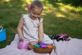 Green Toys Rainbow Bloom set color-change flowers reveal cold-water magic.