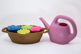 Green Toys Rainbow Bloom set lifelike insert enhances pretend planting play.
