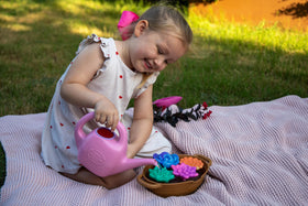 Green Toys Rainbow Bloom set display for outdoor garden play.