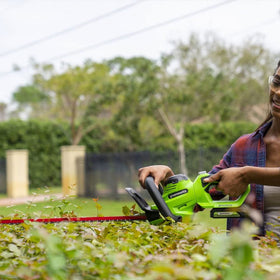 Greenworks hedge trimmer wrap-around handle for versatile angles.