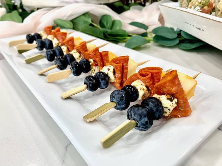 GuGen bamboo paddle picks in use at a dinner table, versatile for fruit and snacks.