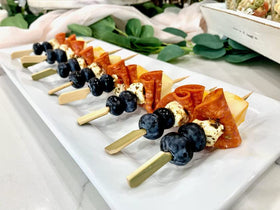 GuGen bamboo paddle picks in use at a dinner table, versatile for fruit and snacks.