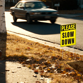 GXGGUS Neighborhood safety sign aids drivers to slow down near homes.