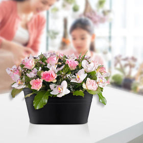 Floral arrangement on patio using GYATSOCYG oval planters for vibrant decoration.