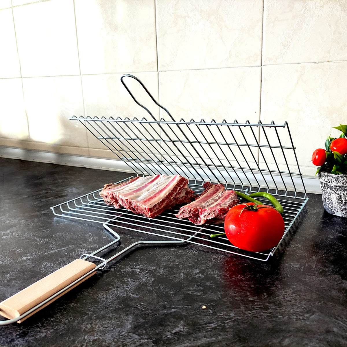Locking mechanism on Hakan grill basket securing food on grill
