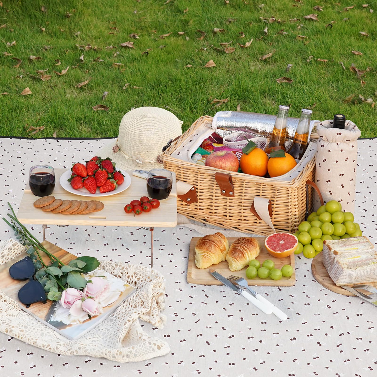 HappyPicnic compact folding picnic table set up on grass.