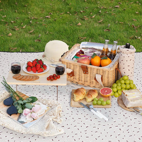 HappyPicnic compact folding picnic table set up on grass.