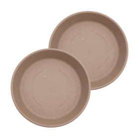 The HC Companies 14in round sandstone saucer catching excess water under a plant pot.