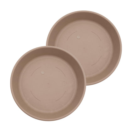 The HC Companies 14in round sandstone saucer catching excess water under a plant pot.